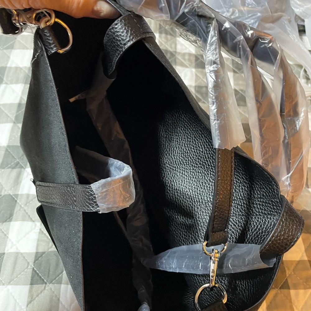 Leigh large reversible black purse with shoulder strap and zip change pouch.